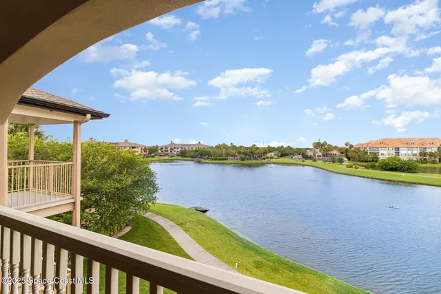 an aerial view of a house with a lake view