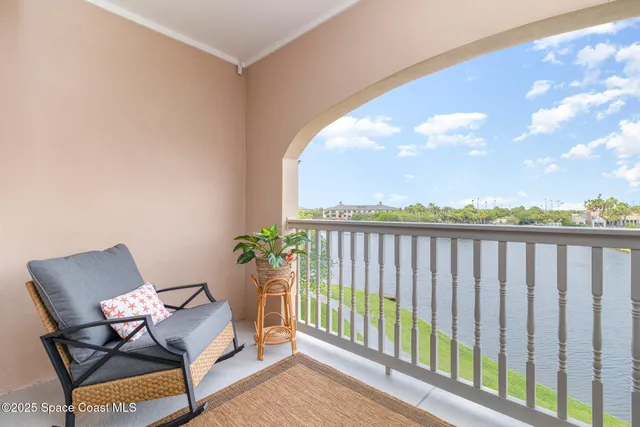 an aerial view of a house with a yard and lake view