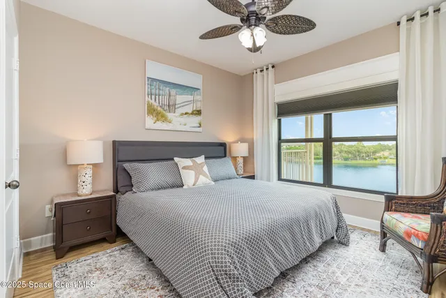 an aerial view of residential houses with outdoor space and lake view