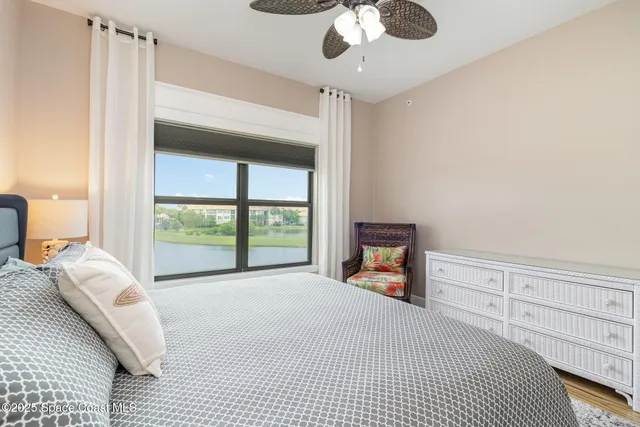an aerial view of residential houses with outdoor space and ocean view