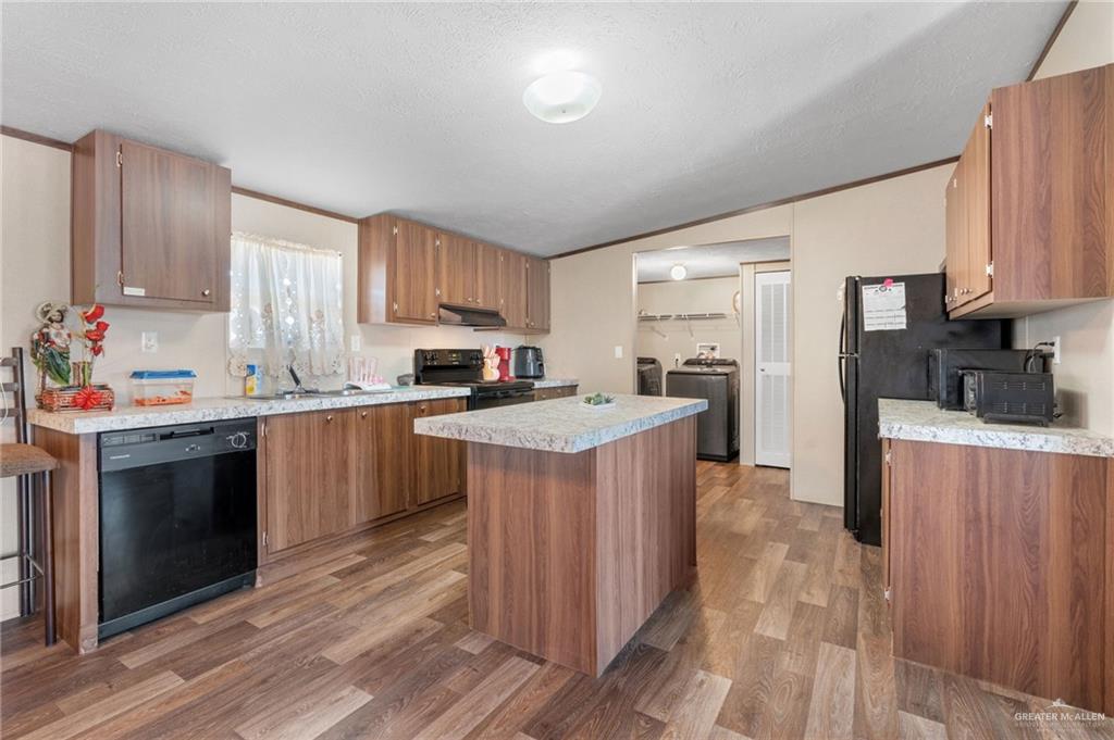 1415 Spear Street Weslaco, TX 78596 - Photo 3 of 14 a kitchen with a stove top oven sink and cabinets