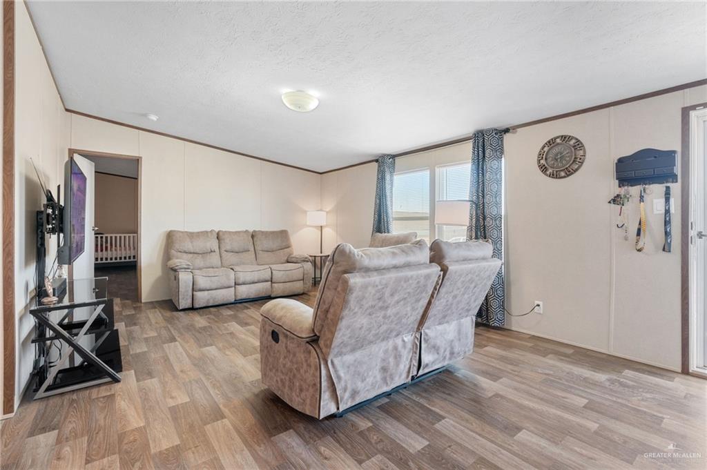 1415 Spear Street Weslaco, TX 78596 - Photo 5 of 14 a living room with furniture a rug and white walls
