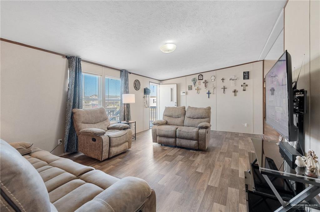 1415 Spear Street Weslaco, TX 78596 - Photo 6 of 14 a living room with furniture and a flat screen tv