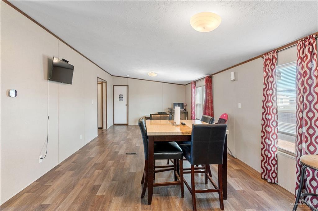 1415 Spear Street Weslaco, TX 78596 - Photo 7 of 14 a view of a dining room with furniture and wooden floor