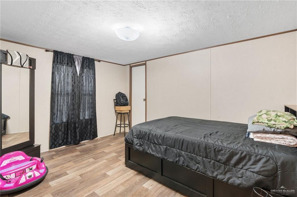1415 Spear Street Weslaco, TX 78596 - Photo 9 of 14 a bedroom with a bed and a dresser