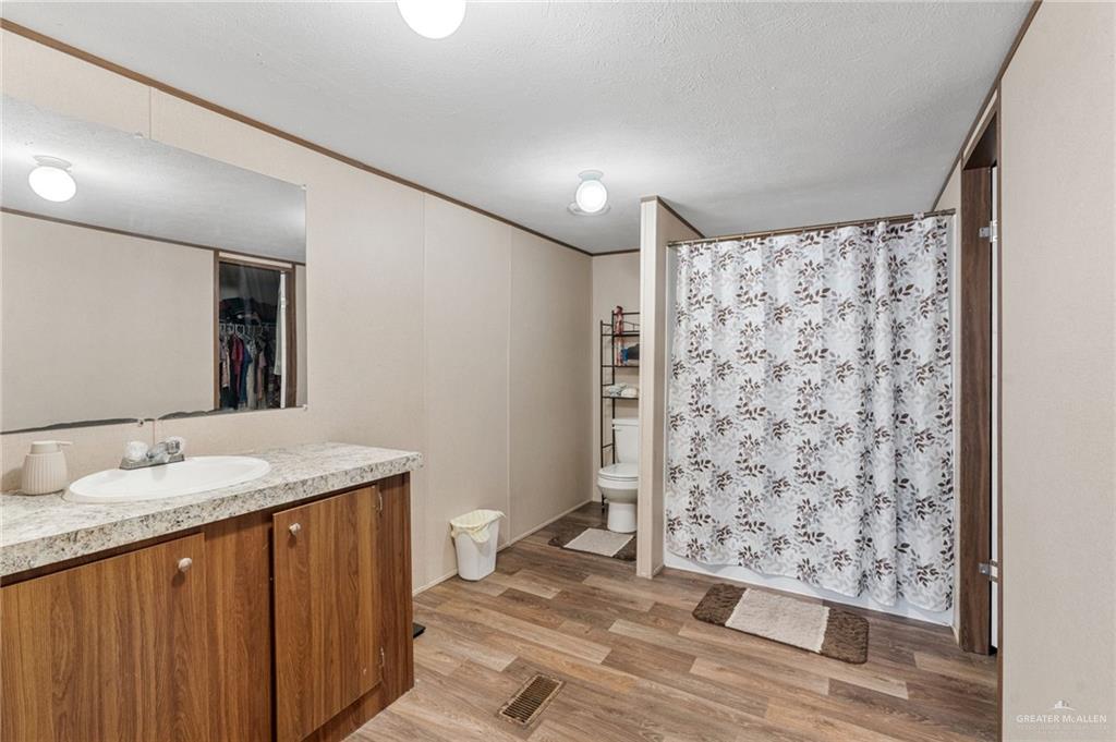 1415 Spear Street Weslaco, TX 78596 - Photo 10 of 14 a bathroom with a sink and a mirror