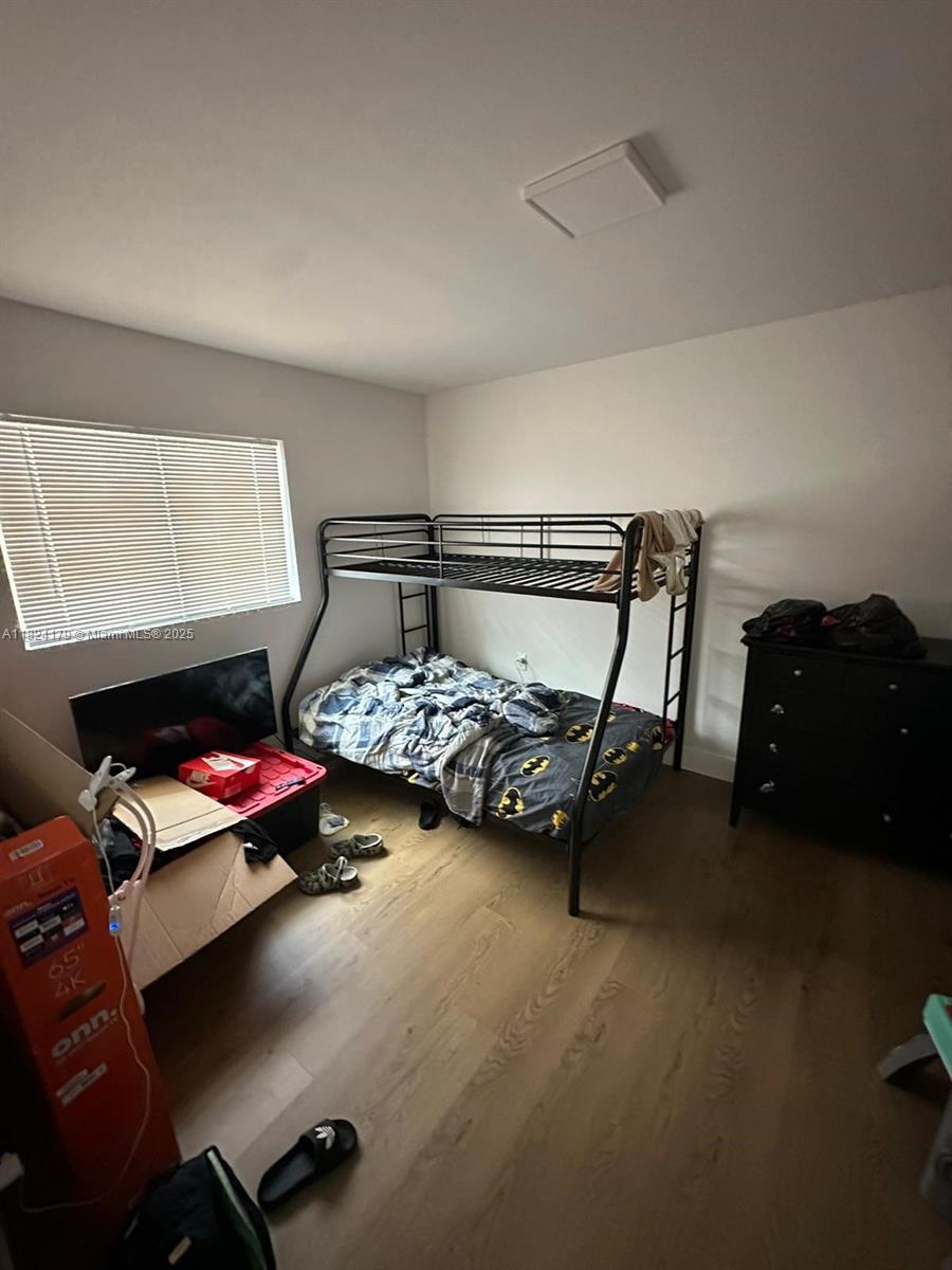 147 Northwest 61st Street Miami, FL 33127 - Photo 12 of 17 a bedroom with a bed and a lamp