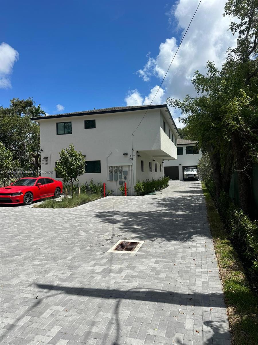 147 Northwest 61st Street Miami, FL 33127 - Photo 2 of 17 a front view of a house with cars parked