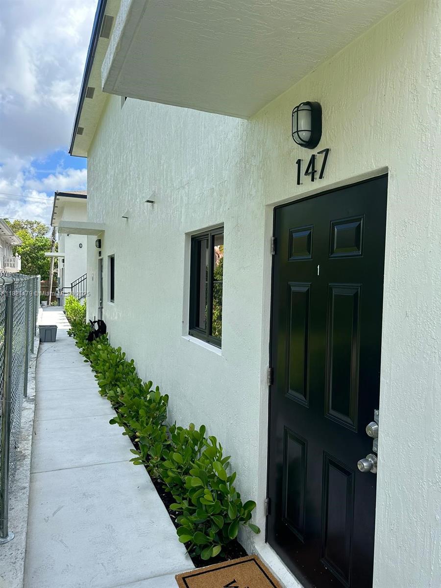 147 Northwest 61st Street Miami, FL 33127 - Photo 4 of 17 a front view of a house with a yard