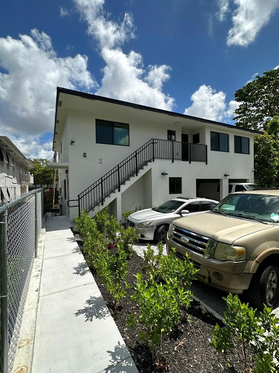 147 Northwest 61st Street Miami, FL 33127 - Photo 5 of 17 a front view of a house with garden