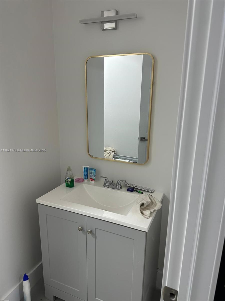 147 Northwest 61st Street Miami, FL 33127 - Photo 8 of 17 a bathroom with a sink and a mirror