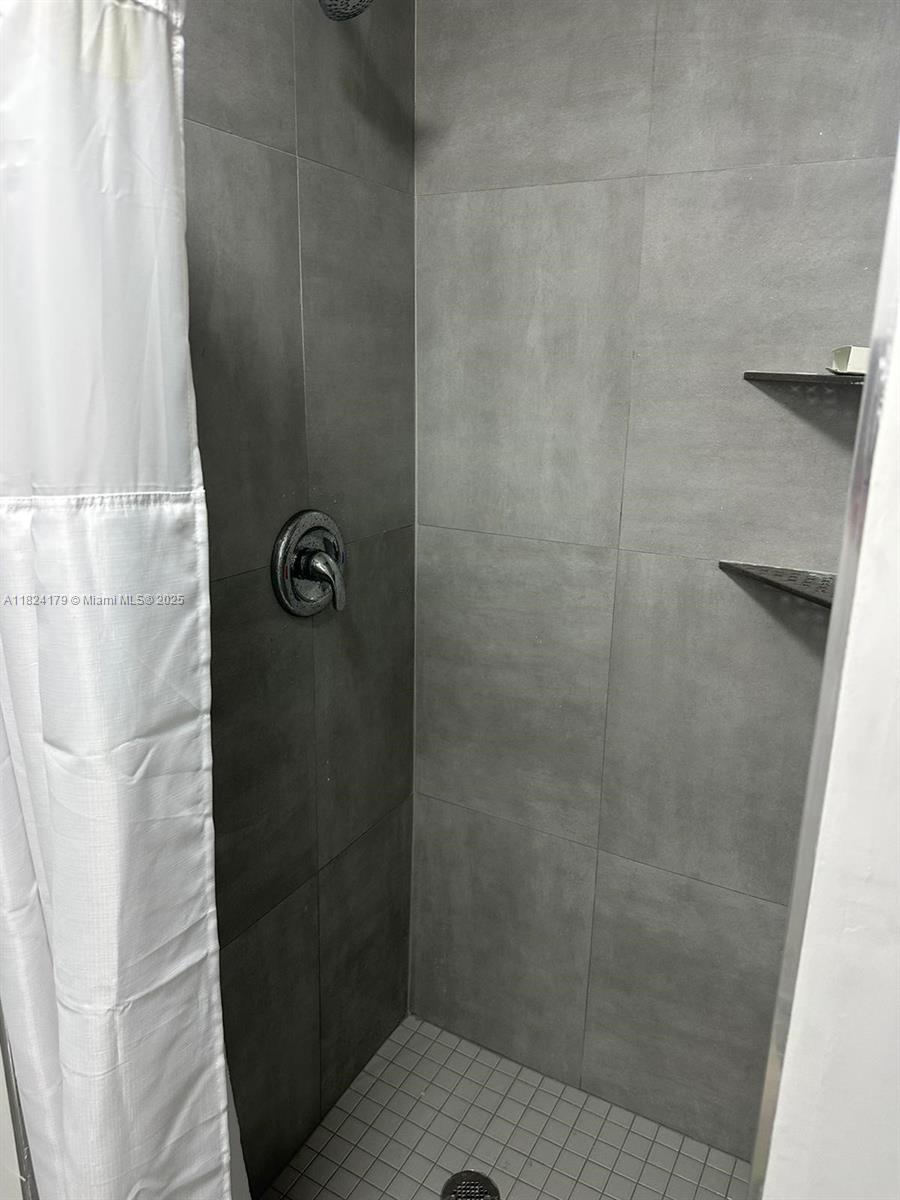147 Northwest 61st Street Miami, FL 33127 - Photo 9 of 17 a bathroom with a shower