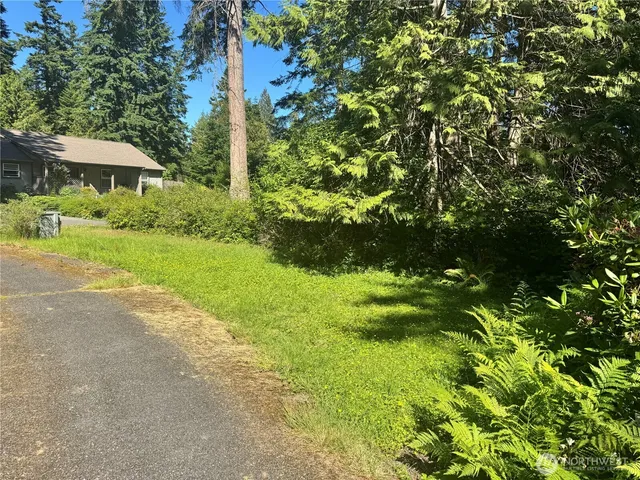 a backyard of a house with yard and outdoor seating