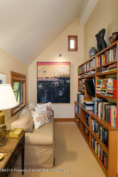 216 Curtis Lane Basalt, CO 81621 - Photo 16 of 32 a living room with furniture a rug and a bookshelf