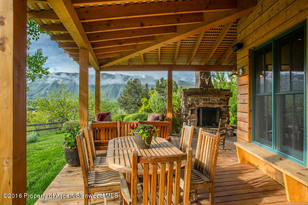 216 Curtis Lane Basalt, CO 81621 - Photo 9 of 32 a view of a patio with table and chairs potted plants with wooden floor and floor to ceiling window