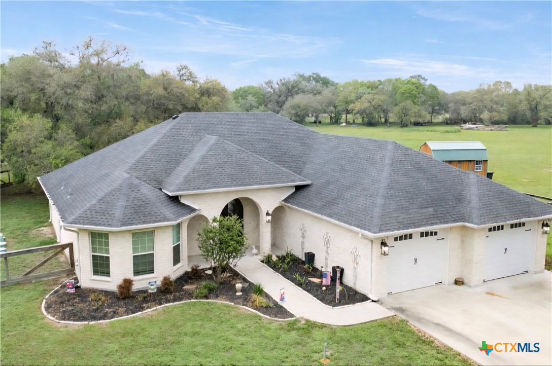 a view of a house with pool and a yard