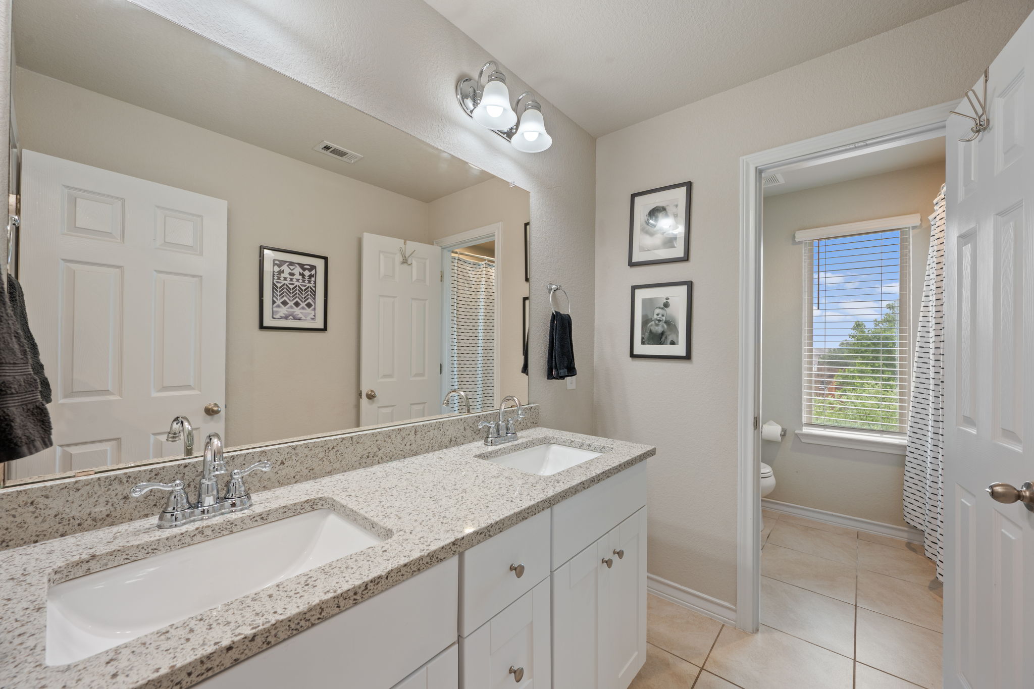 409 Limestone Road Liberty Hill, TX 78642 - Photo 26 of 35 a bathroom with a granite countertop sink and a mirror