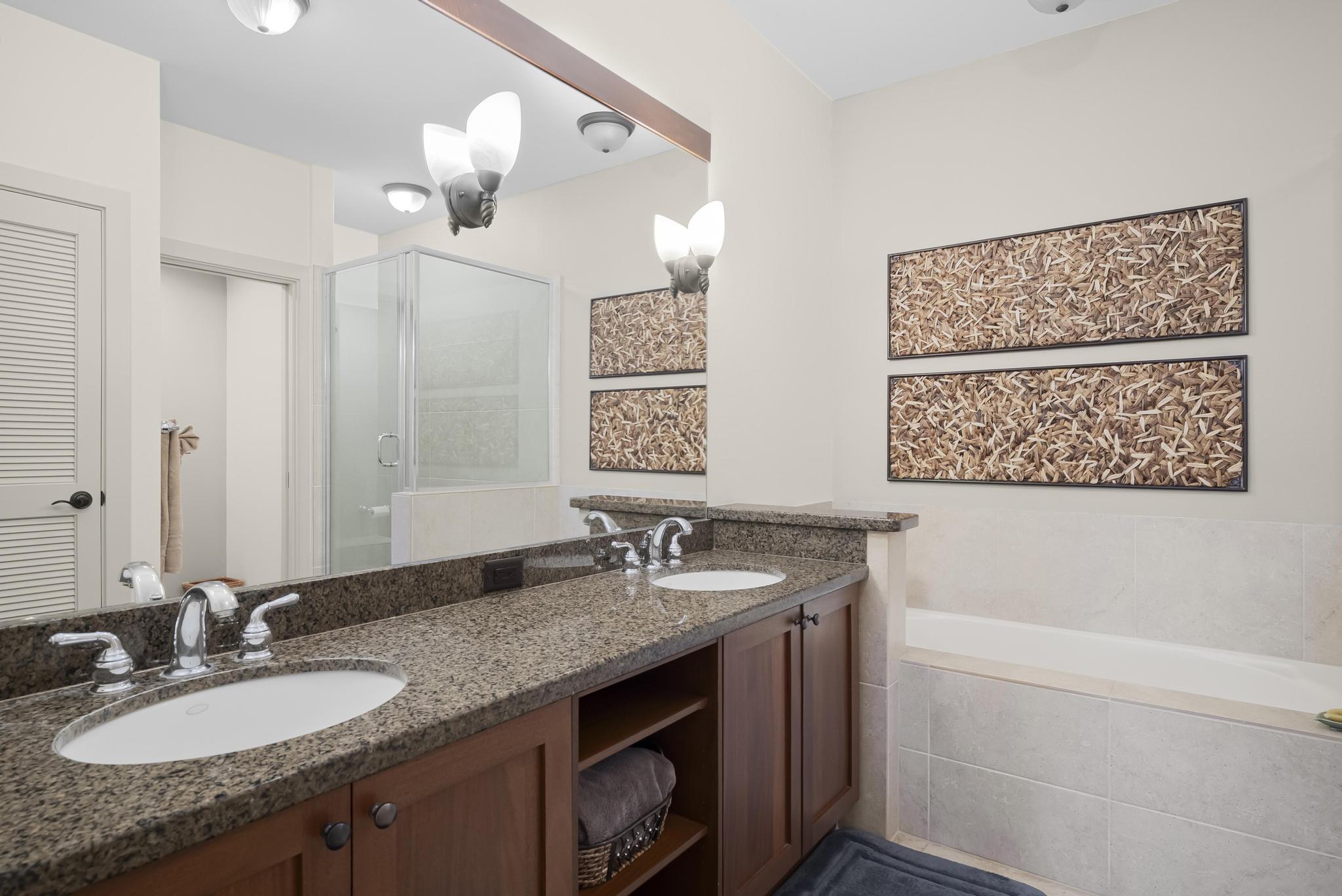 69-1033 Nawahine Place, Unit 18D Waikoloa, HI 96738 - Photo 13 of 25 a bathroom with a granite countertop sink a mirror a vanity and bathtub