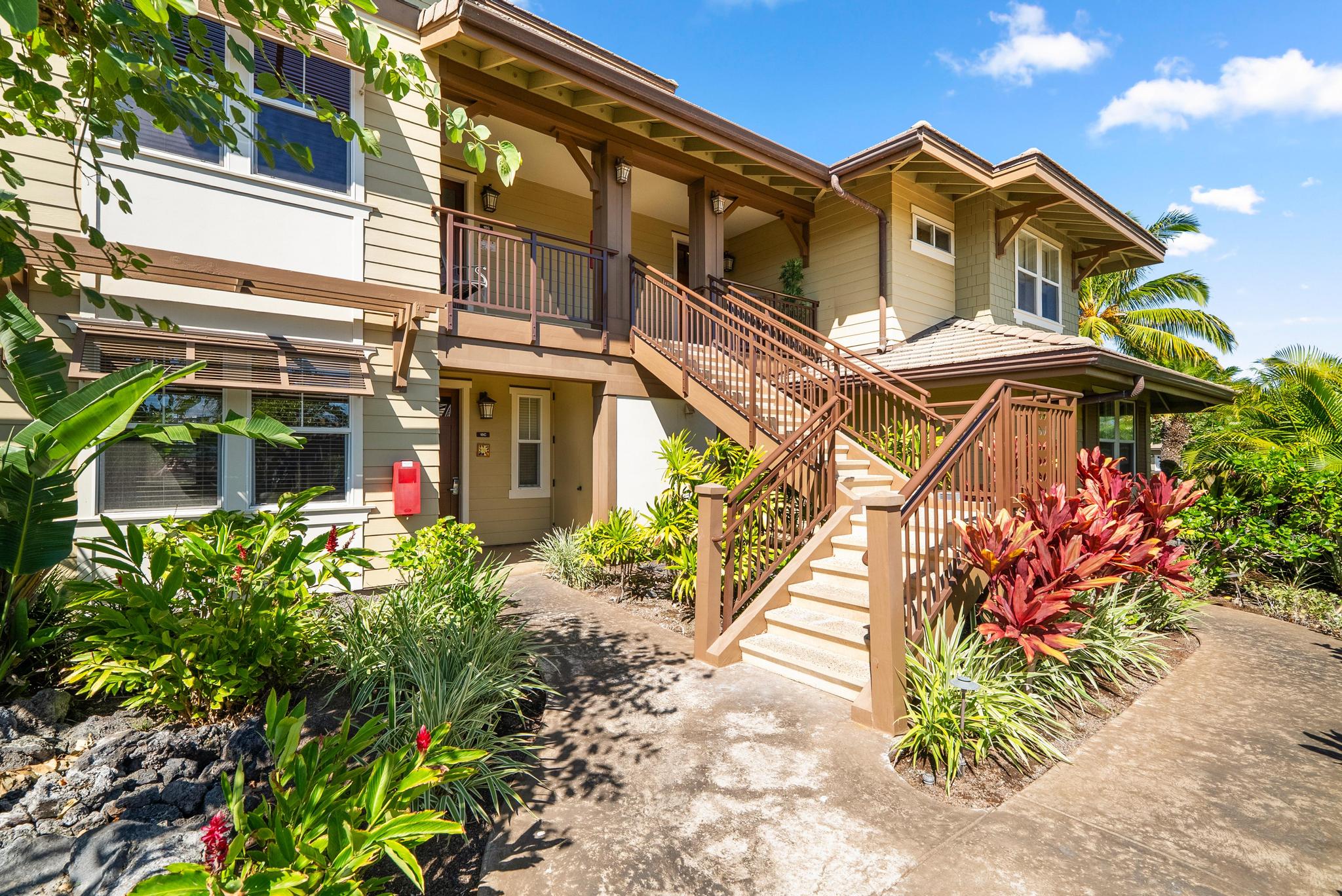 69-1033 Nawahine Place, Unit 18D Waikoloa, HI 96738 - Photo 18 of 25 a front view of a house with a yard and flowers