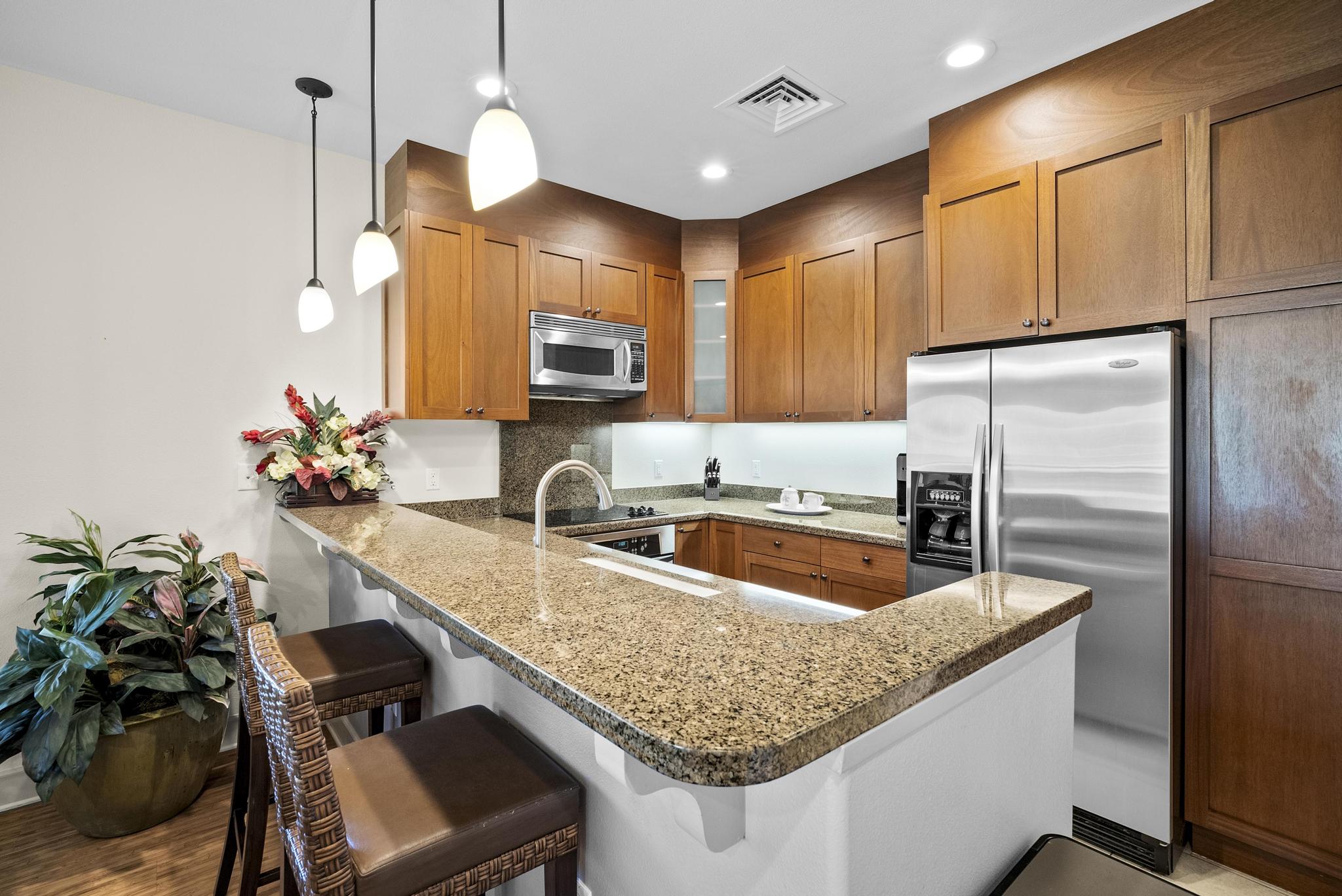 69-1033 Nawahine Place, Unit 18D Waikoloa, HI 96738 - Photo 5 of 25 a kitchen with kitchen island granite countertop a sink appliances and cabinets