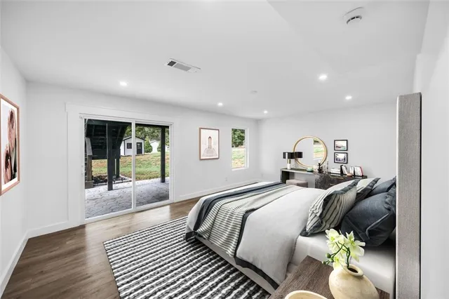 a spacious bedroom with a bed and a table