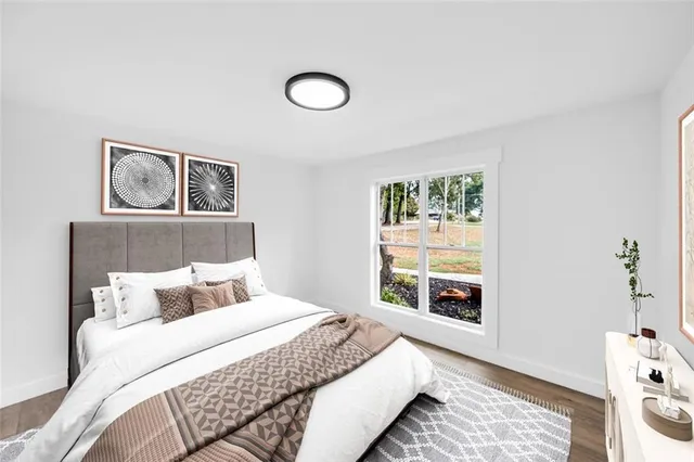 a bedroom with furniture and wooden floor