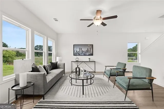 a kitchen with stainless steel appliances kitchen island granite countertop a table chairs sink and cabinets