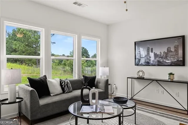 a kitchen with a sink a microwave a stove and cabinets