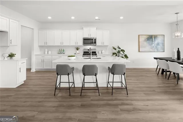 a kitchen with white cabinets and a sink