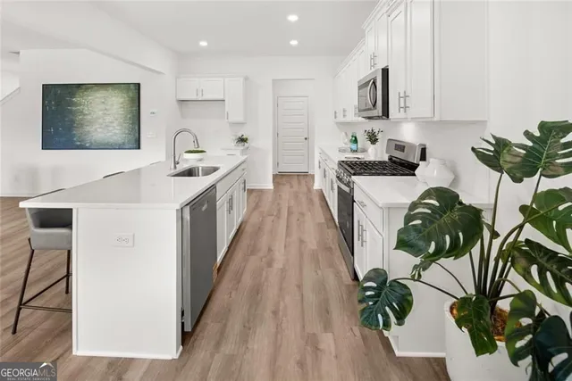 a room with a wooden floor and white walls