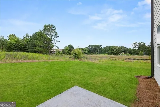 a view of a house with backyard and porch