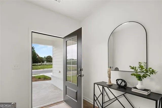 a living room with furniture kitchen view and a chandelier