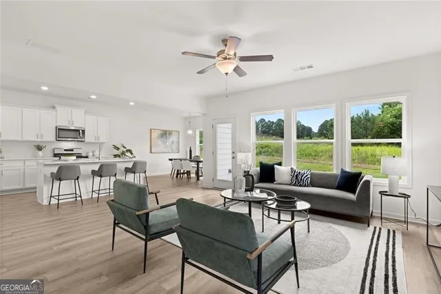 a living room with furniture and a large window