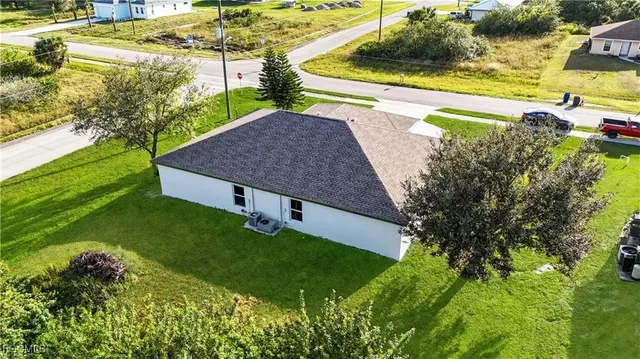 a view of a backyard with plants and lake view