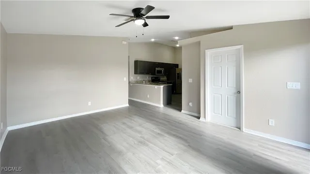a view of a kitchen with a sink and a refrigerator