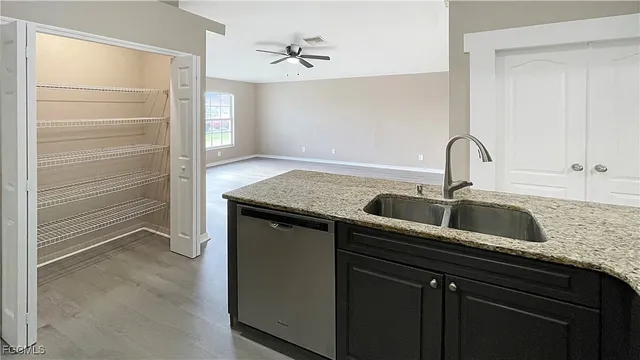 a kitchen with a sink and a refrigerator