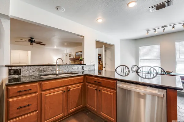 a kitchen with sink and cabinets