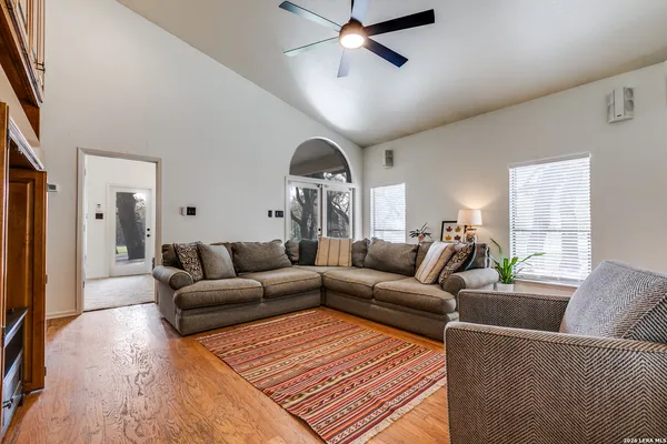 a living room with furniture a ceiling fan and a rug