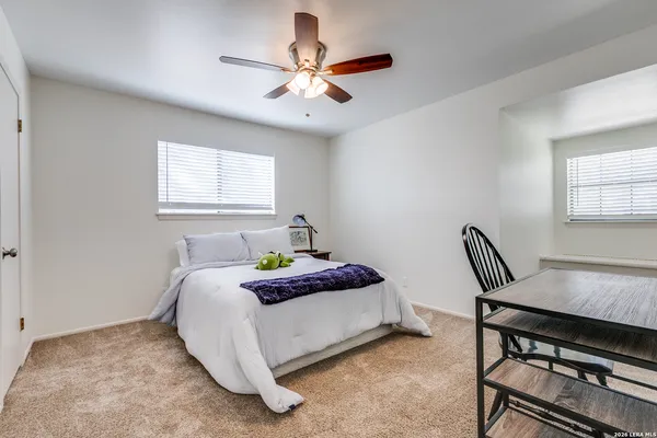 a bedroom with a bed chairs and window