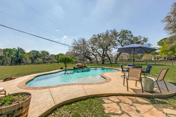 a view of a swimming pool with a patio