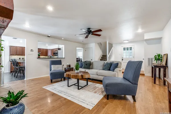 a living room with furniture a wooden floor and a chandelier