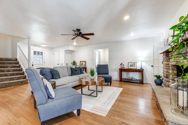 a living room with furniture fireplace and a potted plant