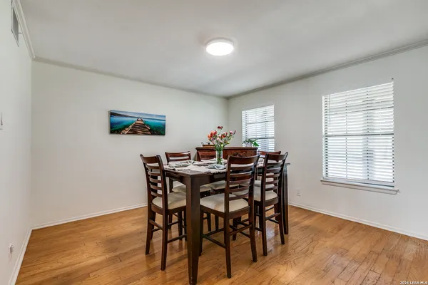 a view of a dining room with furniture and wooden floor