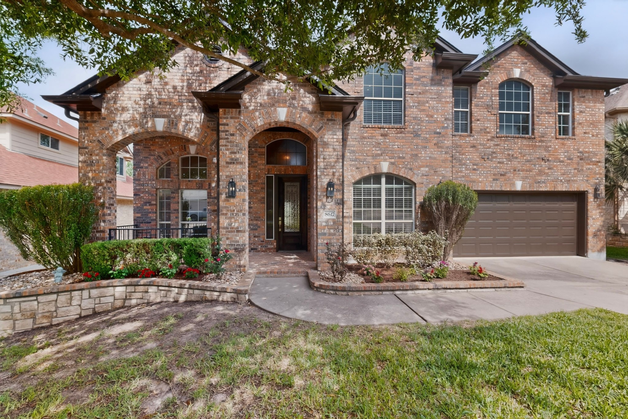 8617 Cobblestone Austin, TX 78735 - Photo 2 of 39 a front view of a house with a yard