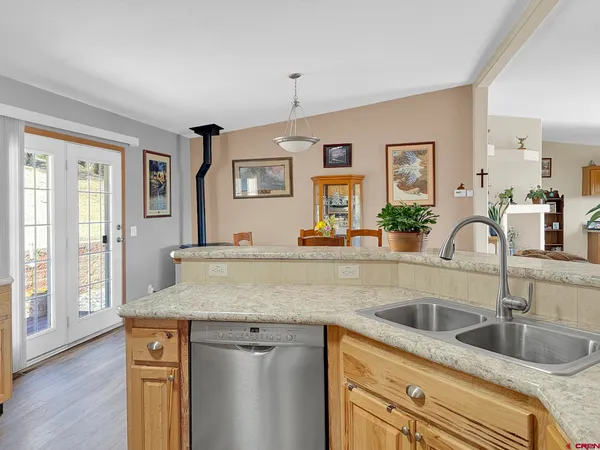 a kitchen with granite countertop stainless steel appliances sink and cabinets