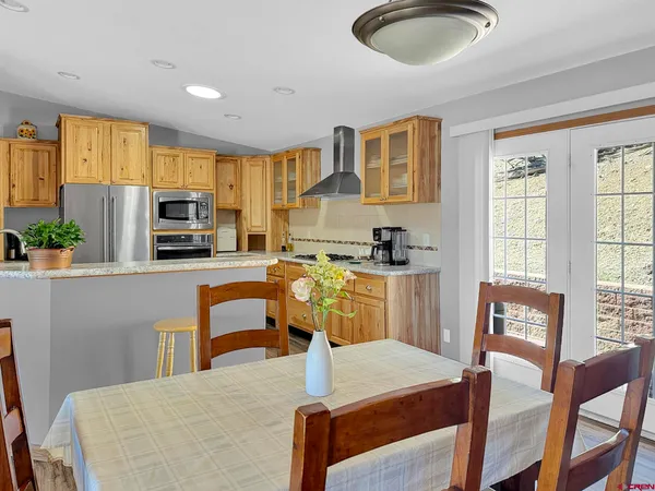 a living room with stainless steel appliances kitchen island granite countertop furniture and a kitchen view