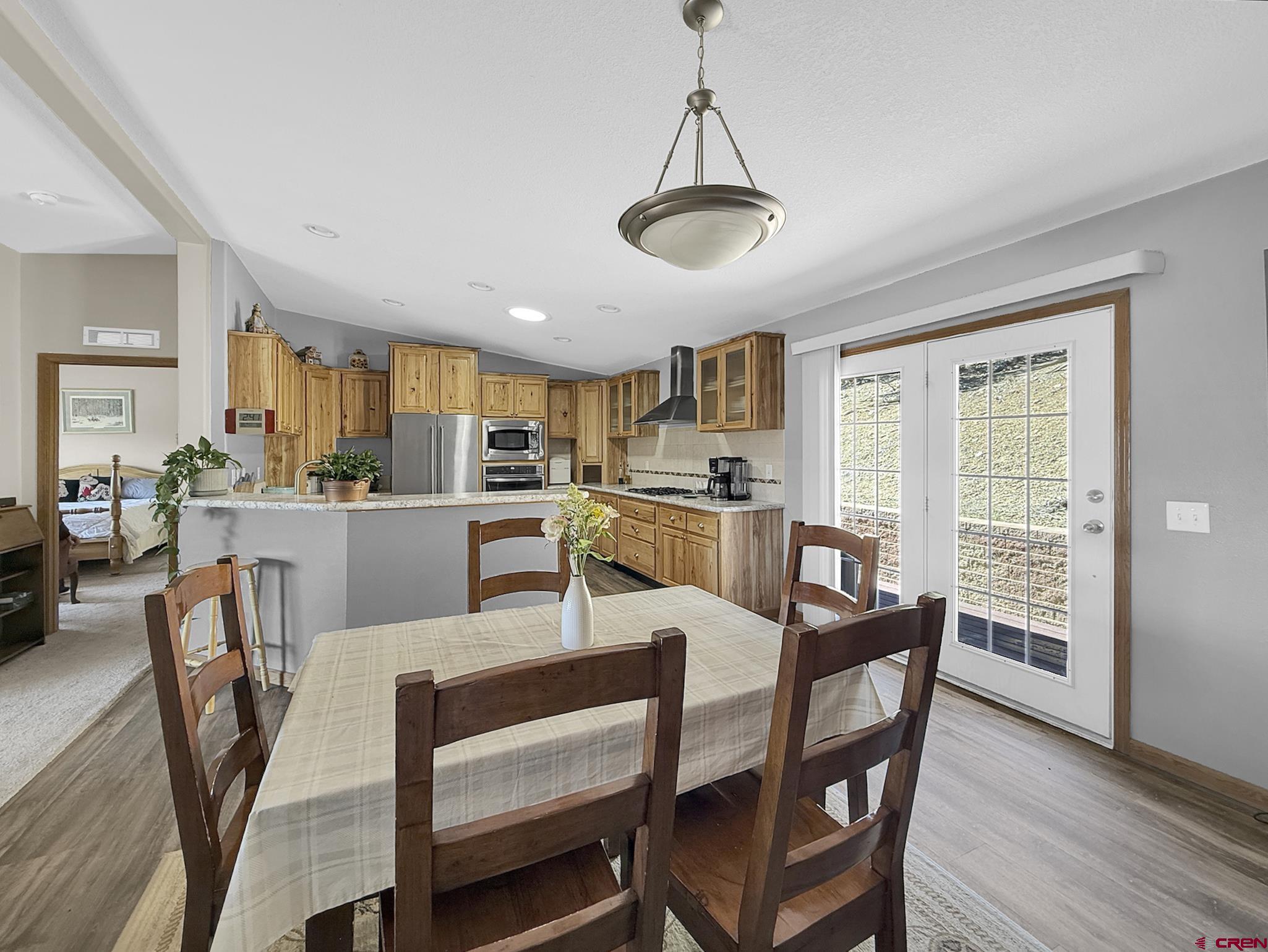 40331 D Road Crawford, CO 81415 - Photo 21 of 45 a dining room with furniture a chandelier and wooden floor