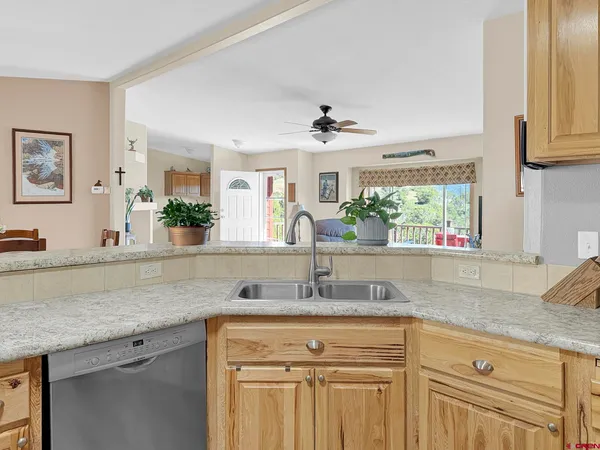 a kitchen with sink cabinets and wooden floor