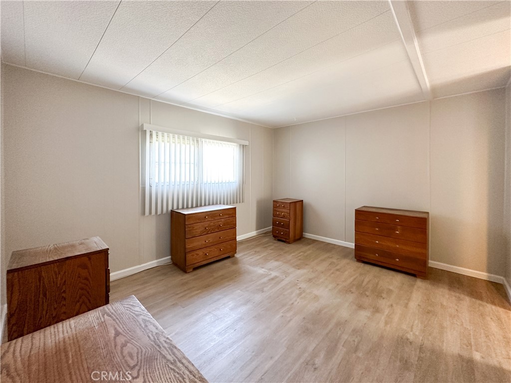 80 Huntington Street, Unit 707 Huntington Beach, CA 92648 - Photo 13 of 16 a room with furniture and a window