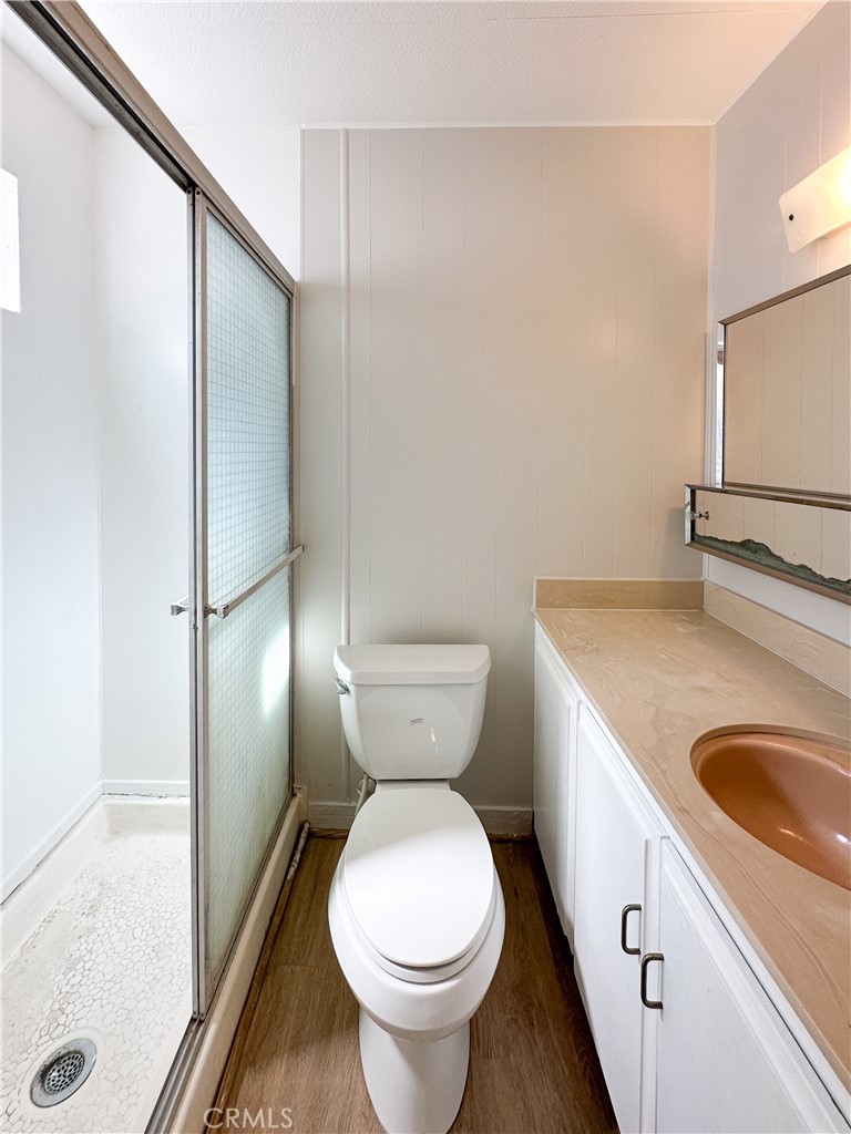 80 Huntington Street, Unit 707 Huntington Beach, CA 92648 - Photo 15 of 16 a bathroom with a toilet sink and mirror